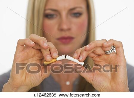 Young woman breaking cigarette View Large Photo Image Stock Photography - Young woman breaking cigarette. Fotosearch