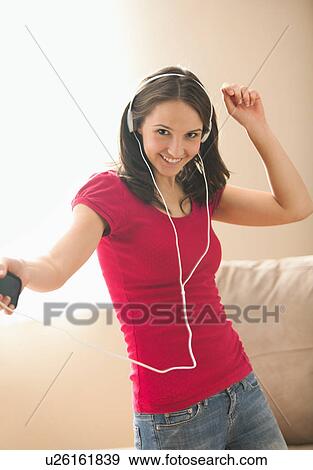 Young woman listening music and dancing View Large Photo Image Stock Photo - Young woman listening music and dancing. Fotosearch