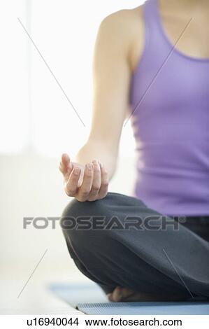 Picture - Young woman meditation in lotus position. Fotosearch