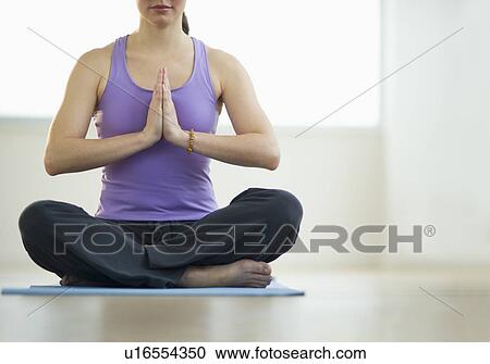 Young woman meditation in lotus position View Large Photo Image Stock Image - Young woman meditation in lotus position. Fotosearch