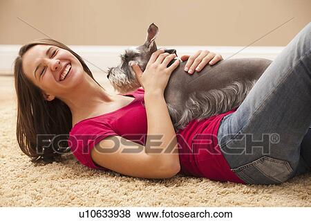 Young woman playing with schnauzer View Large Photo Image Stock Photo - Young woman playing with schnauzer. Fotosearch