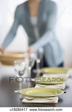 Young woman setting table View Large Photo Image Stock Photo - Young woman setting table. Fotosearch