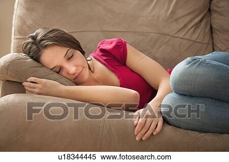 Young woman sleeping on sofa View Large Photo Image Stock Photography - Young woman sleeping on sofa. Fotosearch
