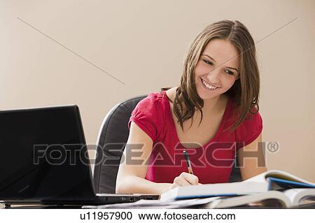 Stock Image - Young woman studying. Fotosearch