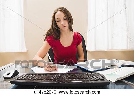 Stock Image - Young woman studying. Fotosearch