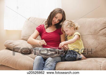 Young woman with sister (2-3) tying newspapers for recycling View Large Photo Image Stock Image - Young woman with sister (2-3) tying newspapers for recycling. Fotosearch
