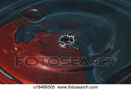 Stock Photography - a drop of water hitting a surface of water. Fotosearch