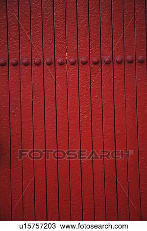 Stock Image - a red wall with rivets; troutdale, oregon, united states of america. Fotosearch