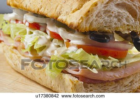 Stock Image - A Sandwich With Meat, Vegetables And Olives. Fotosearch