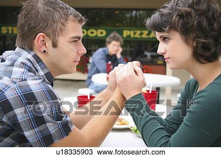 a young couple in a fight as a young man looks on; troutdale, oregon, united states of america View Large Photo Image Stock Image - a young couple in a fight as a young man looks on; troutdale, oregon, united states of america. Fotosearch