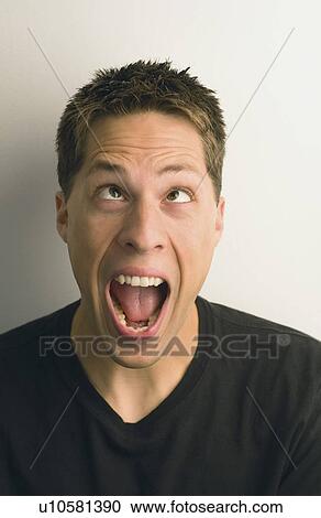 Stock Image - a young man making a silly face; wilmar, minnesota, united states of america. Fotosearch