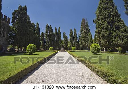 Stock Image - gravel path in the center of a garden; conigliano, veneto, italy. Fotosearch