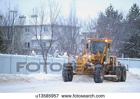 snowplow removes snow off a street; edmonton, alberta, canada View Large Photo Image Stock Photo - snowplow removes snow off a street; edmonton, alberta, canada. Fotosearch