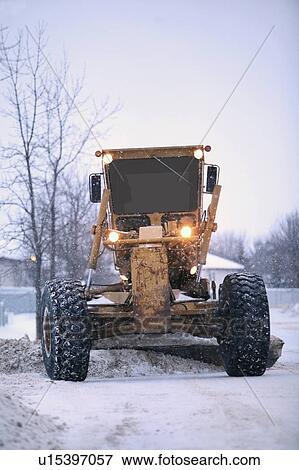 Stock Photo - snowplow removes snow off a street; edmonton, alberta, canada. Fotosearch