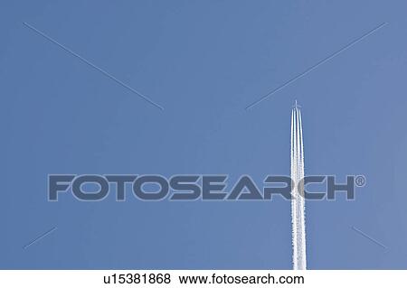 Stock Photo - Airplane on clear sky. Fotosearch