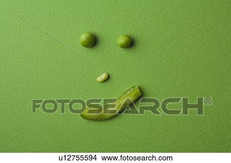 Picture - Anthropomorphic face made up from green peas . Fotosearch