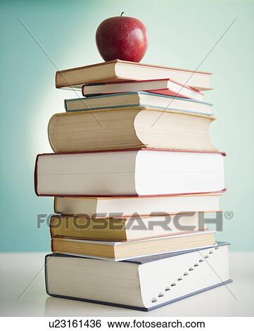 Apple on stack of books View Large Photo Image Stock Photograph - Apple on stack of books. Fotosearch