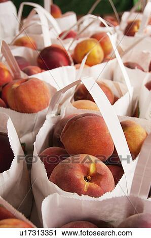 Stock Image - Bags with peaches. Fotosearch