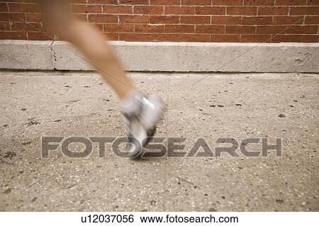 Stock Photograph - Blurred legg of woman jogging. Fotosearch