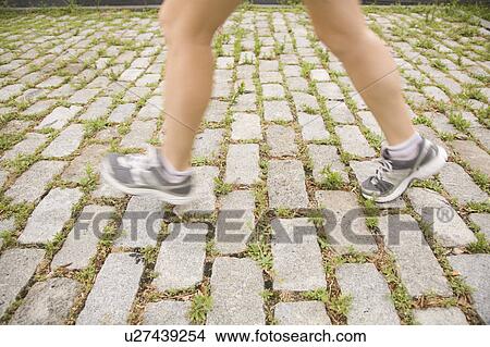 Picture - Blurred legs of woman jogging. Fotosearch