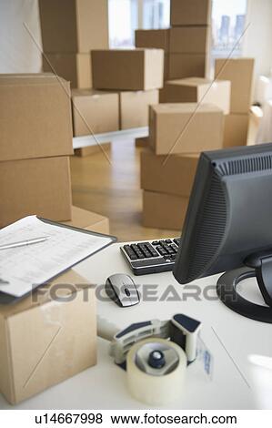 Boxes and computer at delivery warehouse View Large Photo Image Stock Photo - Boxes and computer at delivery warehouse. Fotosearch