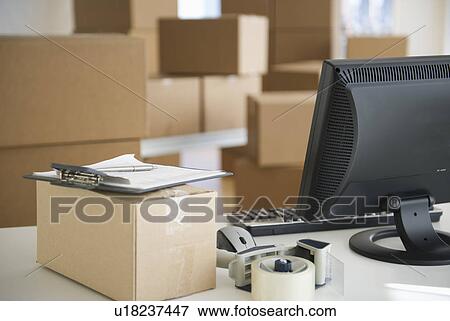 Boxes and computer at delivery warehouse View Large Photo Image Stock Photo - Boxes and computer at delivery warehouse. Fotosearch