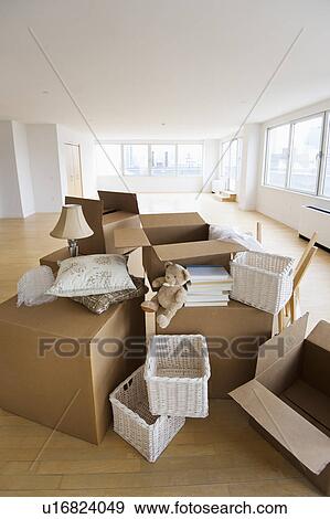 Stock Photo - Boxes and decors stacked in room. Fotosearch