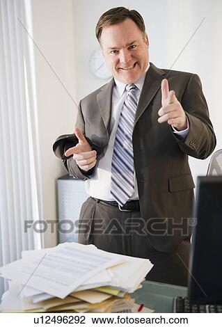 Businessman pointing to camera View Large Photo Image Stock Image - Businessman pointing to camera. Fotosearch