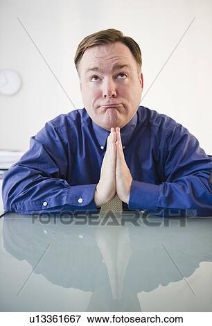 Stock Photo - Businessman praying. Fotosearch
