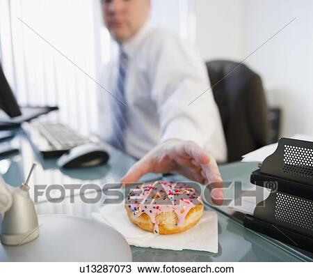 Businessman reaching for donut View Large Photo Image Stock Image - Businessman reaching for donut. Fotosearch