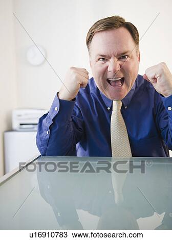 Stock Image - Businessman with clenched fists. Fotosearch