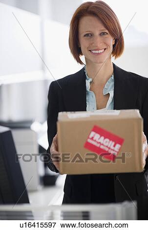 Stock Photo - Businesswoman holding box. Fotosearch