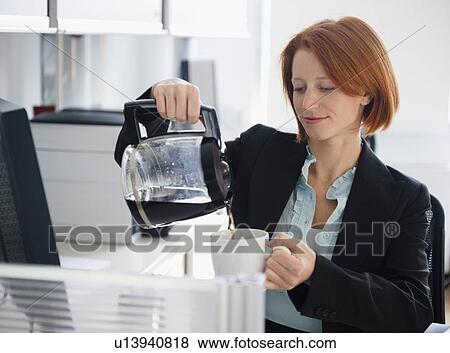 Stock Photo - Businesswoman pouring coffee. Fotosearch
