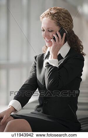 Stock Image - Businesswoman talking on phone. Fotosearch