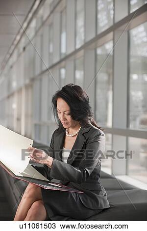 Stock Image - Businesswoman text-messaging. Fotosearch
