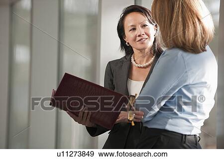 Businesswomen talking in corridor View Large Photo Image Stock Photo - Businesswomen talking in corridor. Fotosearch