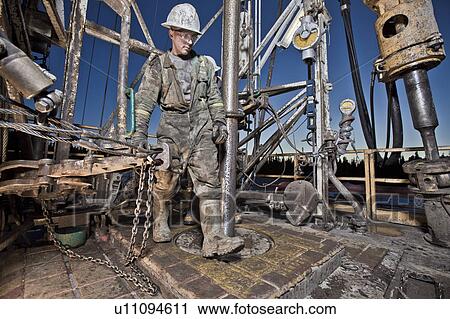 Canada, Alberta, Oil workers using oil drill View Large Photo Image Stock Image - Canada, Alberta, Oil workers using oil drill. Fotosearch