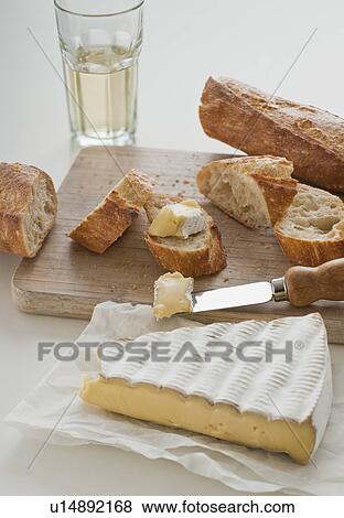 Cheese and baguette on table View Large Photo Image Stock Photo - Cheese and baguette on table. Fotosearch