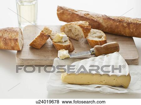 Cheese and baguette on table View Large Photo Image Stock Photo - Cheese and baguette on table. Fotosearch