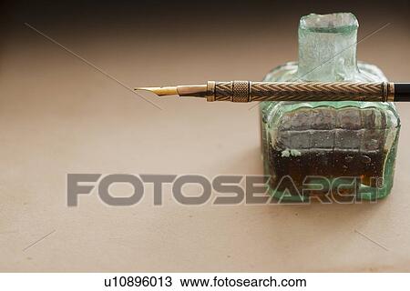 Stock Image - Close up of antique ink well and pen. Fotosearch