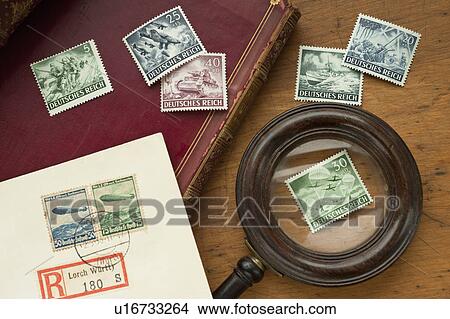 Picture - Close up of antique stamp collection and magnifying glass. Fotosearch
