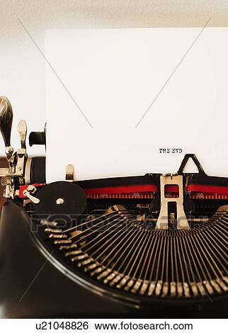 Stock Photograph - Close up of antique typewriter with "the end" print on page. Fotosearch