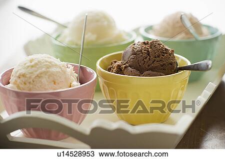 Stock Image - Close up of bowls with ice cream selection on tray. Fotosearch