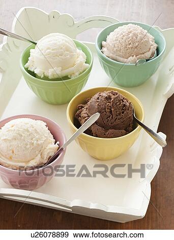Stock Photo - Close up of bowls with ice cream selection on tray. Fotosearch