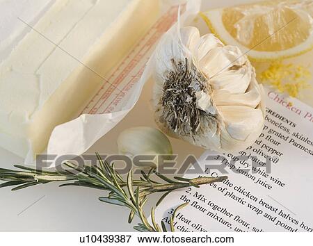 Stock Photo - Close-up of butter, garlic, lemon, rosemary and recipe. Fotosearch