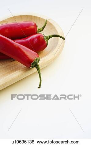Stock Photo - Close up of chili peppers on wooden tray. Fotosearch