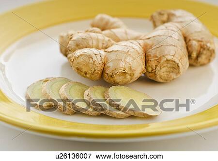Stock Photo - Close up of ginger root and slices. Fotosearch