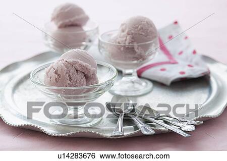 Stock Photograph - Close up of ice cream dessert on silver tray. Fotosearch