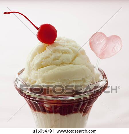 Close up of ice cream dessert with cherry on top and heart shaped decoration View Large Photo Image Stock Image - Close up of ice cream dessert with cherry on top and heart shaped decoration. Fotosearch