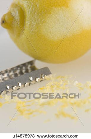 Stock Photo - Close-up of lemon and grater. Fotosearch